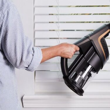 Handheld vacuum cleaning window blinds for daylight saving