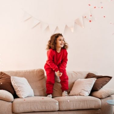 child jumping on the sofa