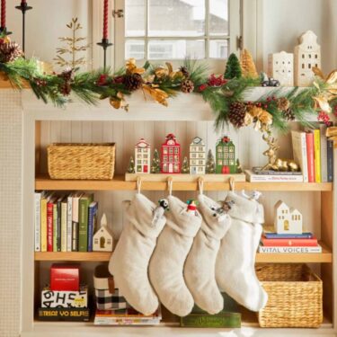 Christmas stockings hung from bookshelf