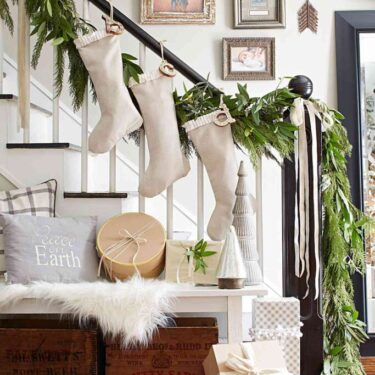 Christmas stockings hung from the railing of the staircase