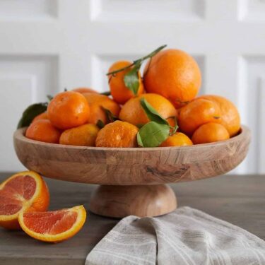 Bowl of oranges displayed as Seasonal Fruit
