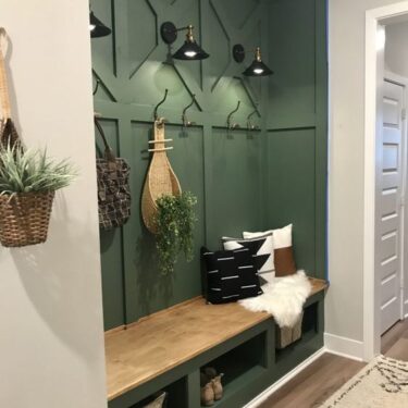 Mudroom area defined by green painted wall