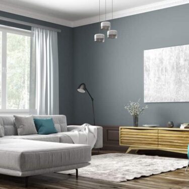 Interior-of-a-contemporary-living-room-with-a-light-silver-sofa-dark-gray-painted-walls-and-a-gray-carpet-on-the-flooring