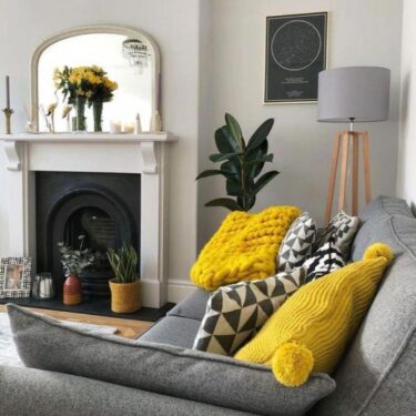 Living room with white walls (60), gray sofa (30) and yellow accent pillows (10)