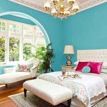 Bedroom with blue walls (60) White bedding and headboard (30) and bright pink accent pillow (10)